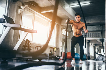 strong man exercising in the sport gym, Handsome man bodybuilder doing workout at gym