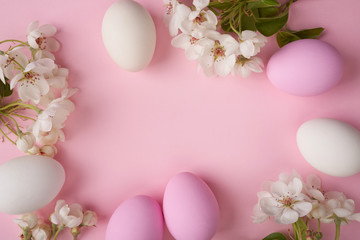 Fototapeta na wymiar Easter eggs with branch of apple blossom on pink background