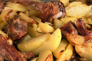Baked potato and lamb meat with rosemary cooked in the oven, bac