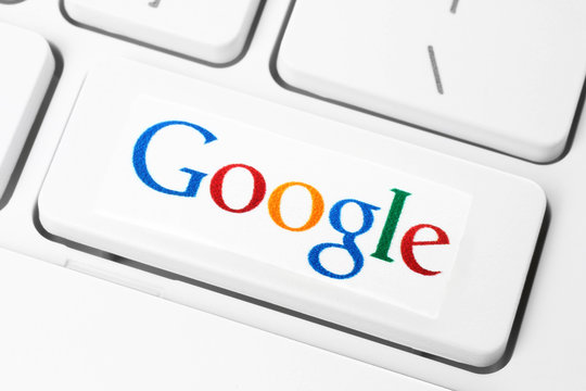 KIEV, UKRAINE - JANUARY 10, 2015: Keyboard with Google logotype, printed on paper and placed on button. Google is USA multinational corporation specializing in Internet-related services and products.