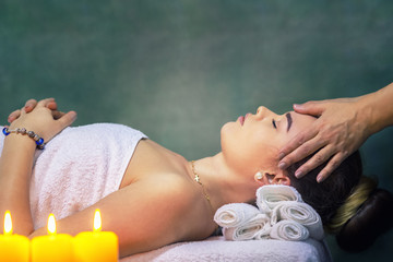 Young woman getting head massage at luxury spa