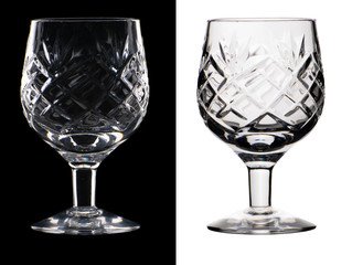 Crystal glass with a relief pattern on a thin leg in two versions isolated on a black and white background