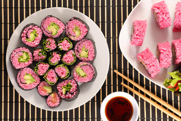vegetarian maki roll with soy sauce- maki cooked with beetroot and avocado © M.studio