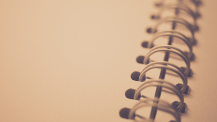 Part of an open spiral notebook with blank paper, closeup photo.