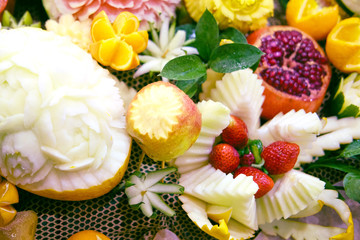 Fruit with a cut pattern in the form of flowers for holiday decoration