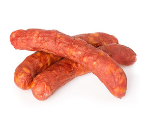 Stack of cooked sausages close-up isolated on white background.