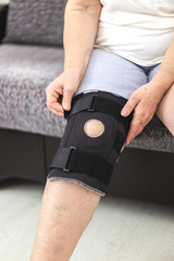 Person who puts on protective knee brace, knee support