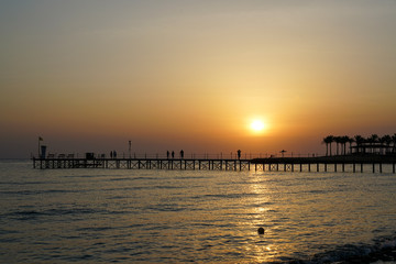 Egypt. People go over the bridge to meet the sunrise in the Red Sea