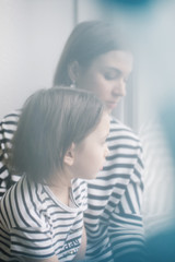 Blurred abstract portrait of young mother and her little daughter