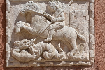 ancient  sculpture of Saint George fighting the dragon