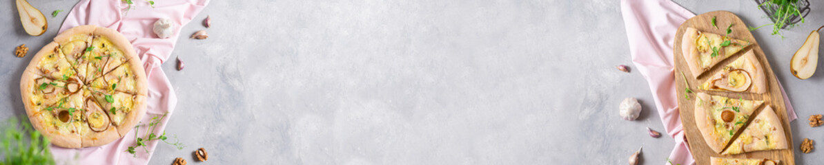 Pizza banner. Delicious pizza with pear, mozzarella, blue cheese, walnuts and microgreen on gray table. Top view, copy space. Italian cuisine. Recipe, spring menu, banner concept