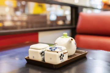 Seasoning set Japanese tableware shoyu sauce and ground cayenne pepper on table at Japanese restaurant. 