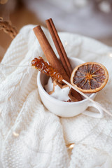Christmas decor. wicker basket, knitted sweater, dried citruses, cinnamon sticks. Cozy.