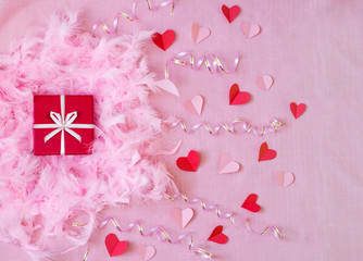 pink background with red present and paper hearts