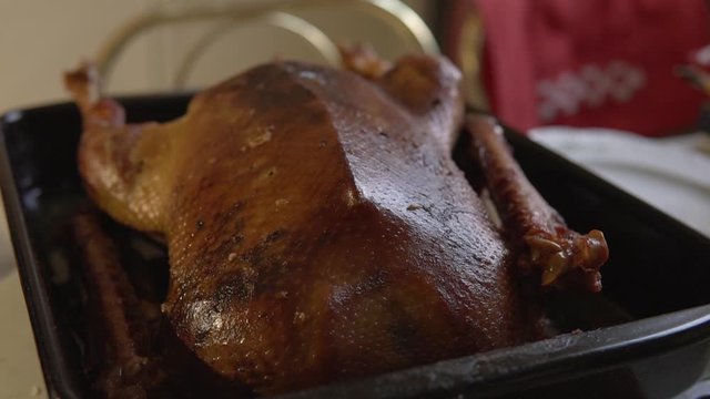 Crispy Goose put out of hot oven on Christmay Holidays for traditional dinner