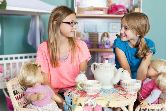 Children and dolls having tea party