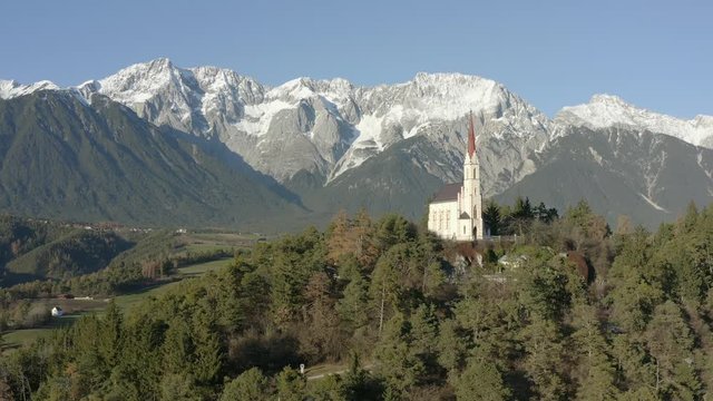 Landscape shot of the great Pilgrimage Church of Maria Locherboden standing on a hill at top Mieming Plateau and high above Inntal Valley.