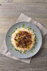Traditional Korean Bulgogi dish.  Thinly cut, grilled beef, served with rice and vegetables.