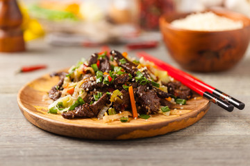 Traditional Korean Bulgogi dish.  Thinly cut, grilled beef, served with rice and vegetables.
