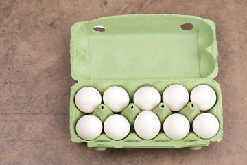 Chicken eggs in a green egg box