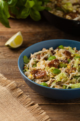 Fried veal, with rice, Chinese cabbage and mushrooms. Sprinkled with sesame and soy sauce.