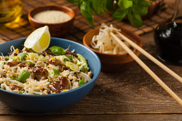 Fried veal, with rice, Chinese cabbage and mushrooms. Sprinkled with sesame and soy sauce.