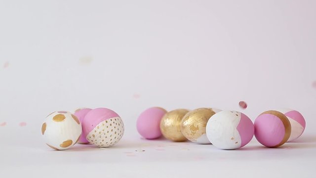 Minimal concept with golden pink pattern of different size egg on a gray background with copy space. Happy easter concept