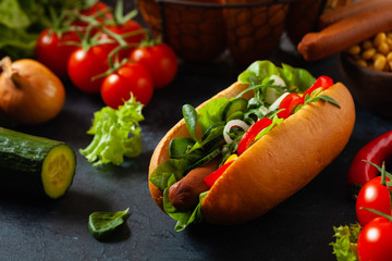 Vegetarian hot dogs with soy sausages and fresh vegetables. Front view.