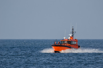 PILOT BOAT -  Orange auxiliary boat on the water