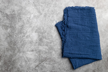 Blue fabric on cement background.