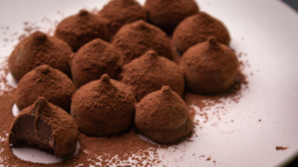 Chocolate truffles in dark background with copy space.