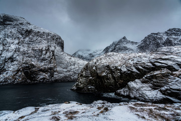 Scenic Nordland landscape photography of  snowy fjord with mountains. Lofoten islands, Norway.