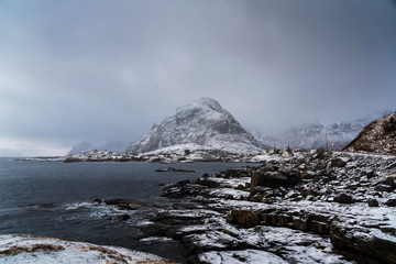 Fototapeta na wymiar Polar landscape winter photography with small village near an outstanding mountain. Lofoten islands, Norway.