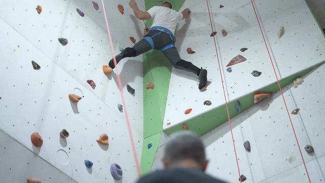 Strong Man Training Climbing On Indoor Climbing Wall