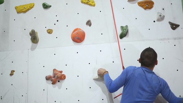 Strong Man Training Climbing On Indoor Climbing Wall