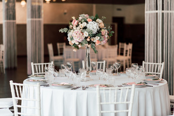 Festive table setting with a floral arrangement in the center and with a table number