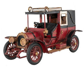 Antique red toy car isolated on white background.