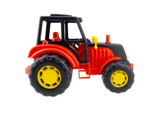 Plastic tractor toy. Side view. Isolated on white background