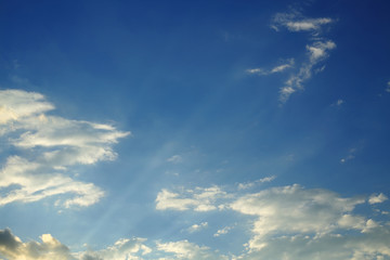 sunlight shine through cloud on dramatic blue sky background