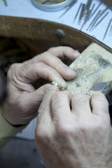 Close-up of a mature man repairing ring