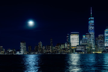 Obraz premium Amazing panorama view on New York City skyline and Downtown Manhattan from Jersey City during night and Full Moon