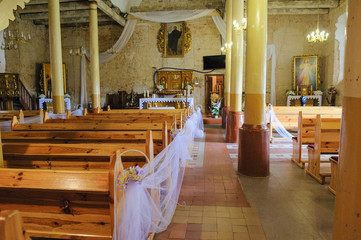 Church sanctuary before a wedding ceremony. Empty chairs for bride and groom.