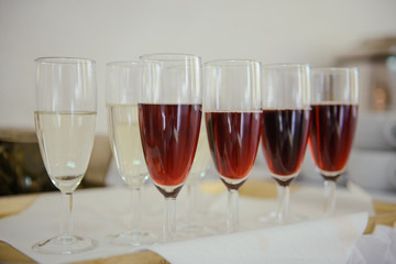 Bottle of cold vodka and wine bottle in bucket with ice and orange juice in jug on table, copy space. Alcohol bottles in ice bucket in restaurant. Wedding party.
