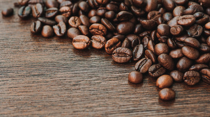 Coffee beans on wood background.
