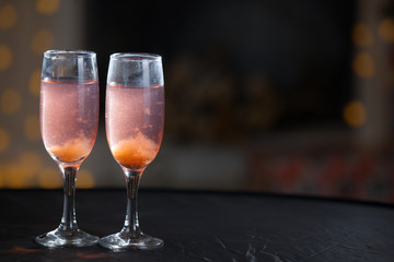 Two glasses of pink champagne for the couple.