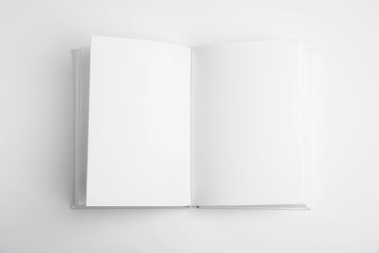 Open book with blank pages on white background, top view
