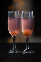 Two glasses of pink champagne for the couple.