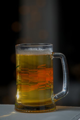 Mug of beer on wooden background