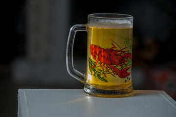 Mug of beer on wooden background
