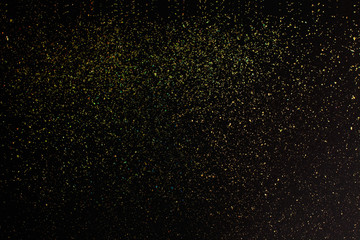 Christmas Gold glitter on black background. Holiday abstract texture